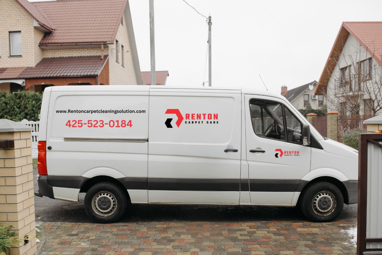 A white van parked outside a house, promoting a carpet and rug cleaning service located in Renton, WA.